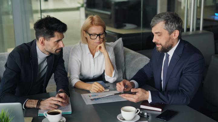 An agent reviewing a financial plan with clients