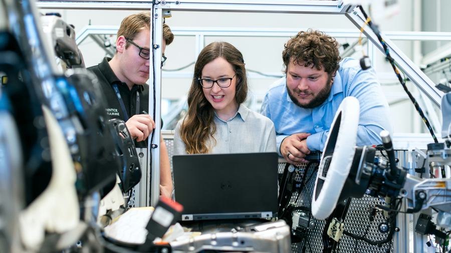 Technicians checking equipment with a laptop