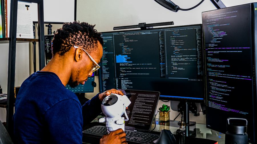 Developer working across several screens