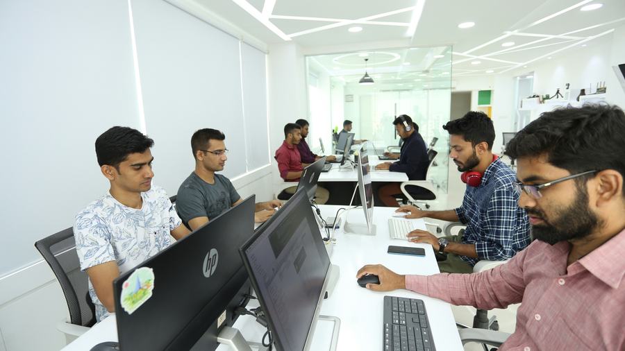 Professionals working at computers in a modern office